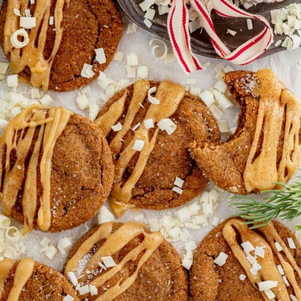 soft gingerbread latte cookies on a counter with a bite missing from one.