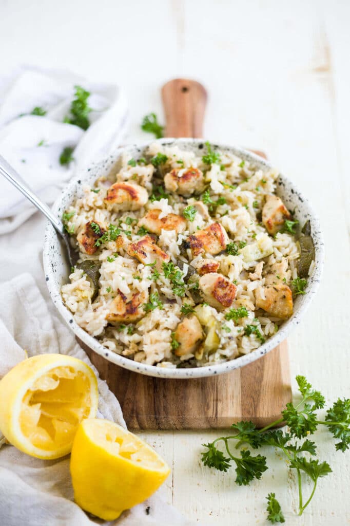 instant pot greek chicken and rice in a bowl with fresh lemon and parsley